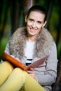 Fashion woman using a tablet computer outside in evening park Royalty Free Stock Photo