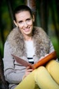 Fashion woman using a tablet computer outside in evening park Royalty Free Stock Photo