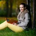 Fashion woman using a tablet computer outside in Royalty Free Stock Photo