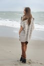Fashion woman walking alone on a sea beach Royalty Free Stock Photo