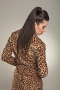 Fashion woman wearing a animal print coat looking down Royalty Free Stock Photo