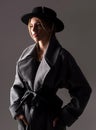 Fashion woman wearing a black round hat. Fashion portrait of glamour sensual young stylish lady wearing trendy outfit.