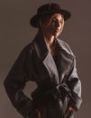 Fashion woman wearing a black round hat. Fashion portrait of glamour sensual young stylish lady wearing trendy outfit.