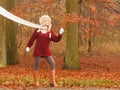 Fashion woman in windy fall autumn park forest. Royalty Free Stock Photo