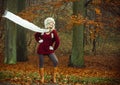 Fashion woman in windy fall autumn park forest. Royalty Free Stock Photo