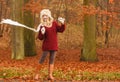 Fashion woman in windy fall autumn park forest. Royalty Free Stock Photo