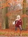 Fashion woman in windy fall autumn park forest. Royalty Free Stock Photo