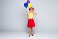 Fashion pretty woman with yellow air balloon over colorful gray background full height Royalty Free Stock Photo
