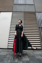 Fashion woman. Young beautiful chinese girl posing over gray metal urban wall background. Stylish trendy lady wearing black dress Royalty Free Stock Photo