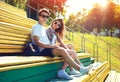 Fashion young couple teenagers resting in the city on bench at summer Royalty Free Stock Photo
