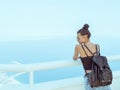 Beautiful young tourist girl with backpack near sea Royalty Free Stock Photo