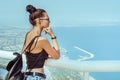 Beautiful young tourist girl with backpack near sea Royalty Free Stock Photo