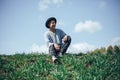 young man model in grey sweater rest sitting on grass in hat Royalty Free Stock Photo