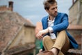 Fashion young man resting and looks to side Royalty Free Stock Photo