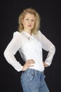 Fashion - Young woman with blouse and jeans standing