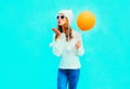 Fashion young woman sends an air kiss holds balloon in white hat Royalty Free Stock Photo