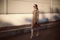 Fashion young woman wearing a leopard dress and handbag clutch Royalty Free Stock Photo