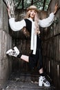 Fashion young woman wearing stylish dress and straw hat at countryside. Amish fashion style.