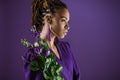 Fashionable african american girl posing with purple eustoma flowers, Royalty Free Stock Photo