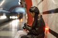 Fashionable asian photographer girl watch picture on camera after walk in city wait for subway train Royalty Free Stock Photo