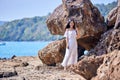 Beautiful asian woman posing on a beach with rocks Royalty Free Stock Photo