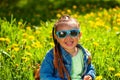 baby girl sitting in sunglasses in the grass on nature Royalty Free Stock Photo