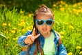 baby girl sitting in sunglasses in the grass on nature Royalty Free Stock Photo