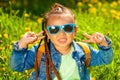 baby girl sitting in sunglasses in the grass on nature Royalty Free Stock Photo