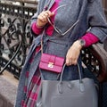 Fashionable bag close-up in female hands.Girl walks in the city outdoors. Stylish modern and feminine image, style. Royalty Free Stock Photo