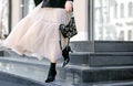 Fashionable bag close-up in female hands.Girl walks in the city outdoors. Stylish modern and feminine image, style. Royalty Free Stock Photo