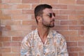 Fashionable bearded man wearing sunglasses and hawaiian style shirt Royalty Free Stock Photo