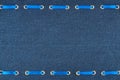 Fashionable beautiful background, blue satin ribbon inserted in denim fabric