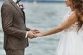 Fashionable and beautiful couple of just married holding hands at a wedding ceremony Royalty Free Stock Photo