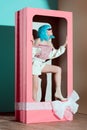 fashionable beautiful girl in blue wig posing in decorative pink box Royalty Free Stock Photo