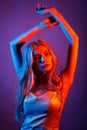 Fashionable beautiful girl dancing in colorful neon lights Royalty Free Stock Photo