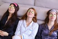 Three charming female friends relax and make facial beauty treat Royalty Free Stock Photo