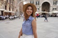 Fashionable beautiful woman strolling in the old town of Verona for her luxury tour in Europe