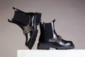 Fashionable black chelsea shoes with chain. boots still life