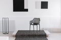 Fashionable black industrial chair in the middle of monochrome interior