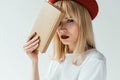 Fashionable blonde girl with red lips holding book Royalty Free Stock Photo