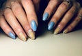 Fashionable blue manicure stylish yellow design drops splatter