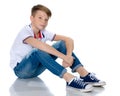 Fashionable boy teen sitting on the floor. Royalty Free Stock Photo