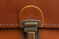 Fashionable brown women`s bag made of genuine leather close-up. Leather bag texture. Fashion concept Details of leather bag belt