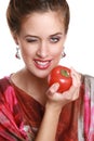 The fashionable brunette with a tomato in hands