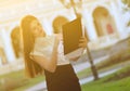 Fashionable business lady looks at paper forms. Portrait of a young brunette woman