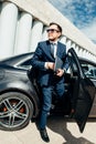 Fashionable businessman coming out of a car Royalty Free Stock Photo