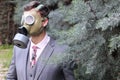 Fashionable businessman wearing gas mask