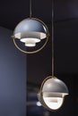 Fashionable chandelier with brass elements, gray modern pendant lamp in loft style. Interesting hemispherical design Royalty Free Stock Photo