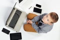 Fashionable child with computers, tablets, phones, gadgets around Royalty Free Stock Photo