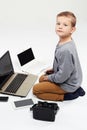 Fashionable child with computers, tablets, phones, gadgets around Royalty Free Stock Photo